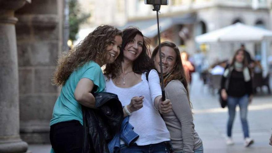 Tres mujeres se hacen un selfi en una calle del centro histórico de Pontevedra. // Gustavo Santos