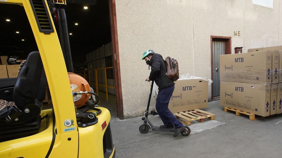 Un treballador arriba en patinet a Ecosol, aVilablareix.
