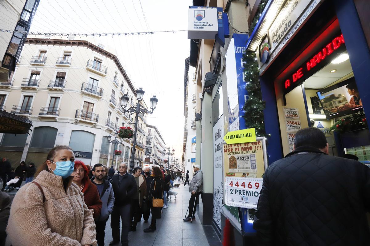 Largas colas para comprar lotería del Niño en una administración de lotería del centro de Zaragoza