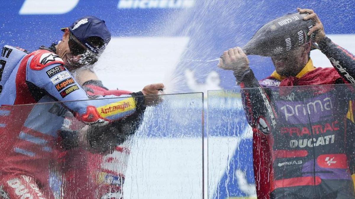 Jorge Martín, a la derecha, ducha con cava a Marc Márquez, en el podio de Le Mans.