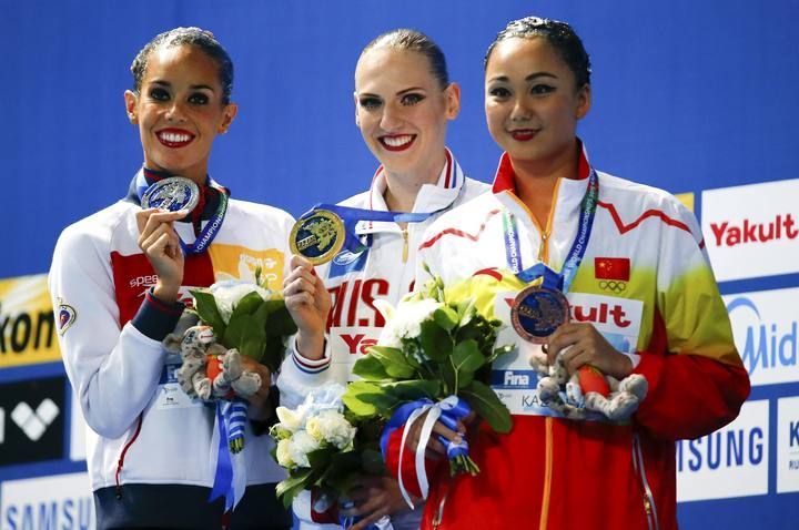 Carbonell of Spain, Romashina of Russia and Sun of China display their medals after the synchronised swimming solo technical final at the Aquatics World Championships in Kazan