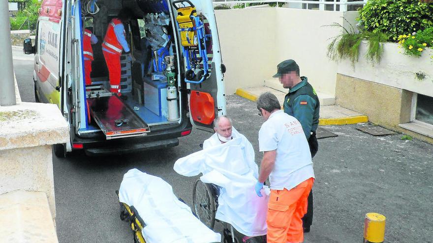 El presunto asesino, con el cuello vendado tras intentar suicidarse, es llevado por los sanitarios bajo custodia de la Guardia Civil a la ambulancia, para su traslado al Hospital de Sant Joan. A la derecha, levantamiento del cadáver de Margaret.