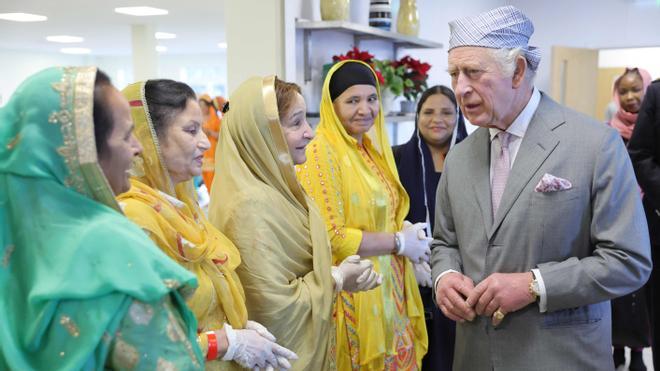 El Rey Carlos III visita una comunidad indú