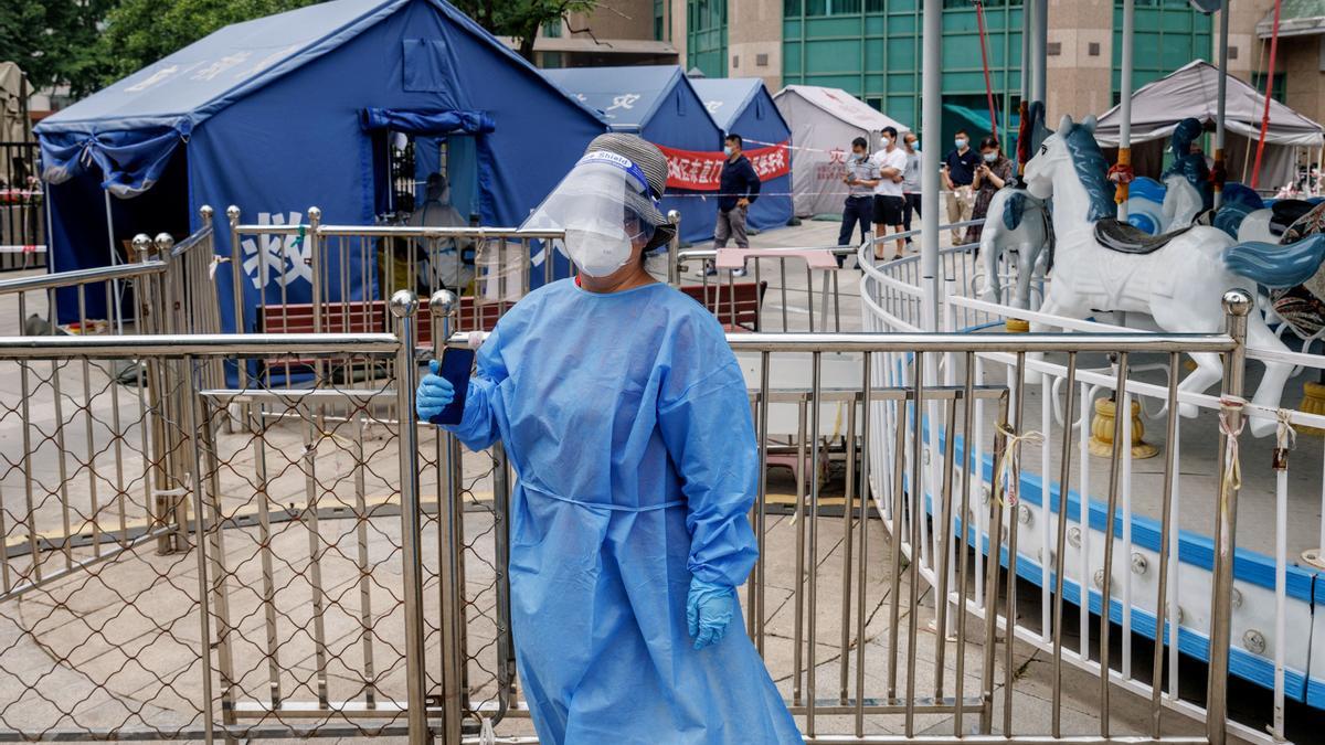 A medical worker in personal protection suit stands at a nucleic acid testing station, following the coronavirus disease (COVID-19) outbreak, in Beijing