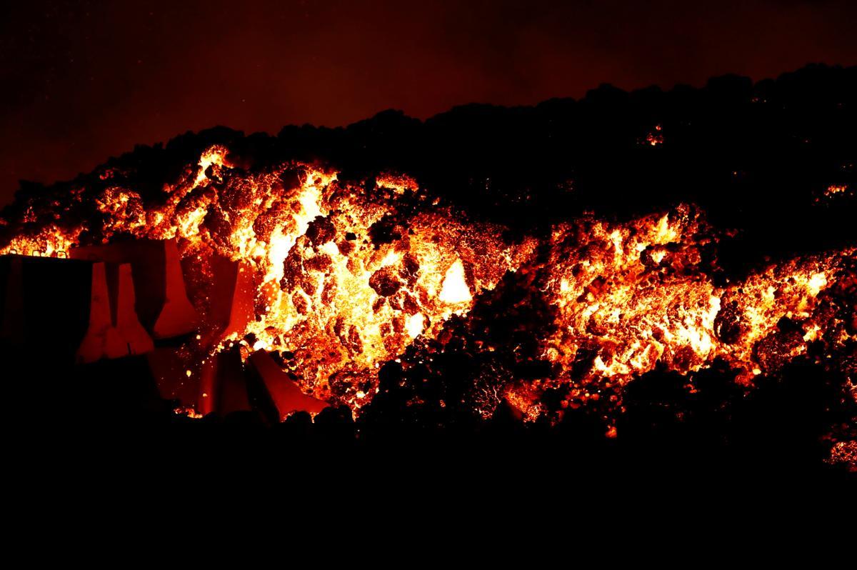 Lava flows downhill following the eruption of a volcano in Spain