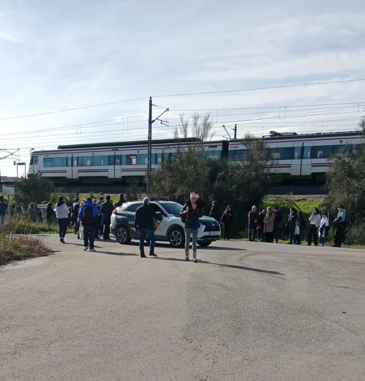 Viajeros desalojados junto a un coche de la Guardia Civil.