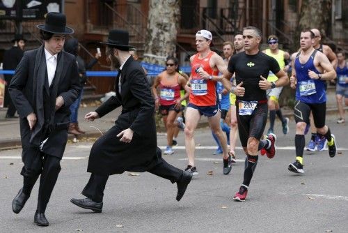 Orthodox Jewish men try to cross Bedford Avenue in the Williamsburg section of the Brooklyn borough during the 2015 New York City Marathon in New York