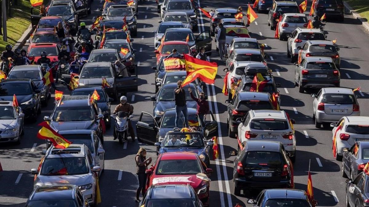 undefined55379736 people wave spanish flags during a drive in protest organise201012161834