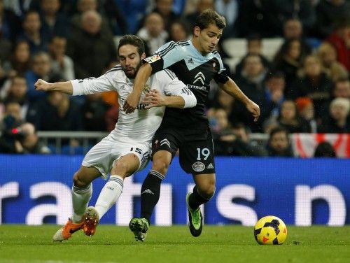 Real Madrid's Carvajal fights for the ball with Celta Vigo's Castro during their Spanish First Division soccer match at Santiago Bernabeu stadium in Madrid