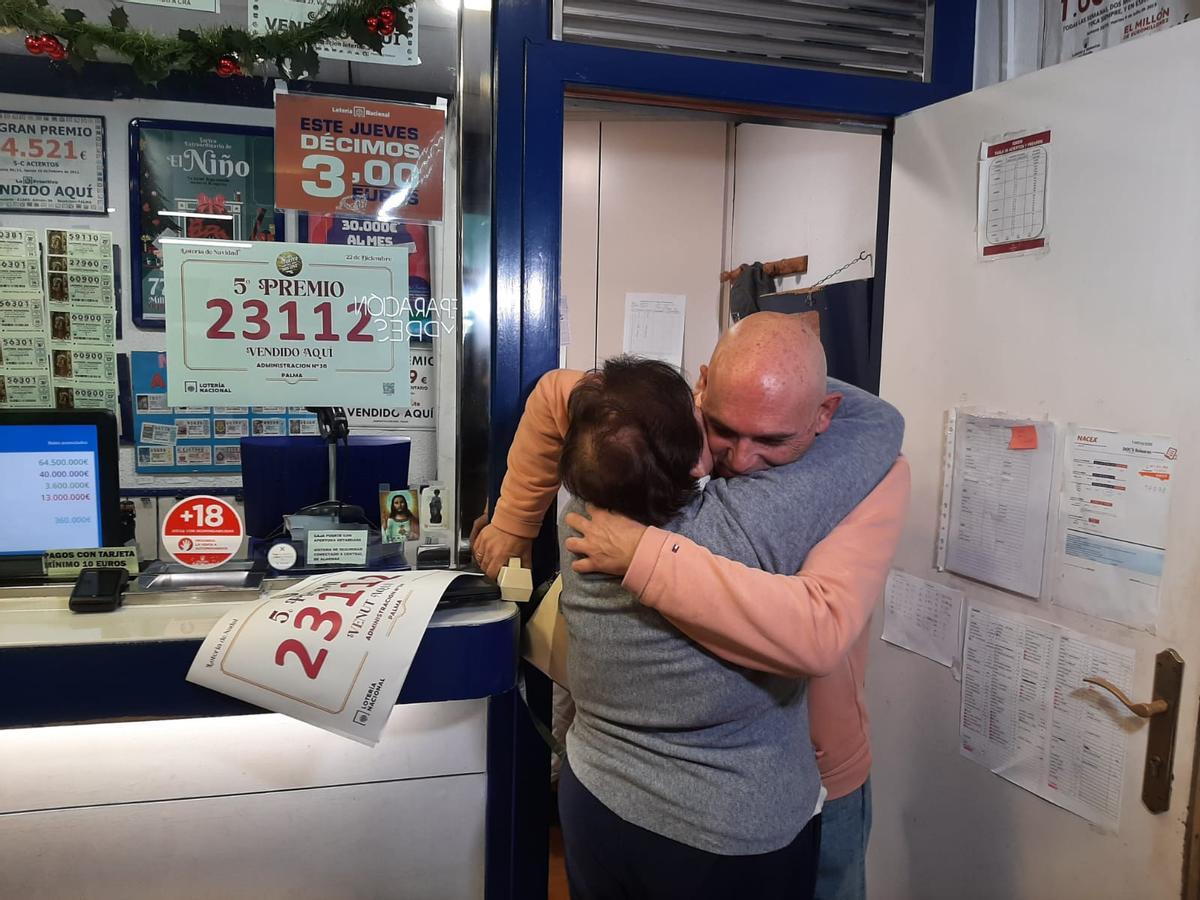 El lotero Andrés Mata abraza a una clienta habitual que le da la enhorabuena