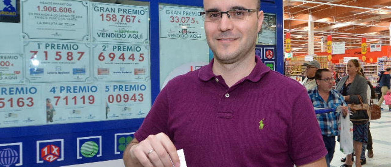 Alberto Suárez muestra el boleto ganador ante la Administración de Loterías número 8 La Brujita de Telde.