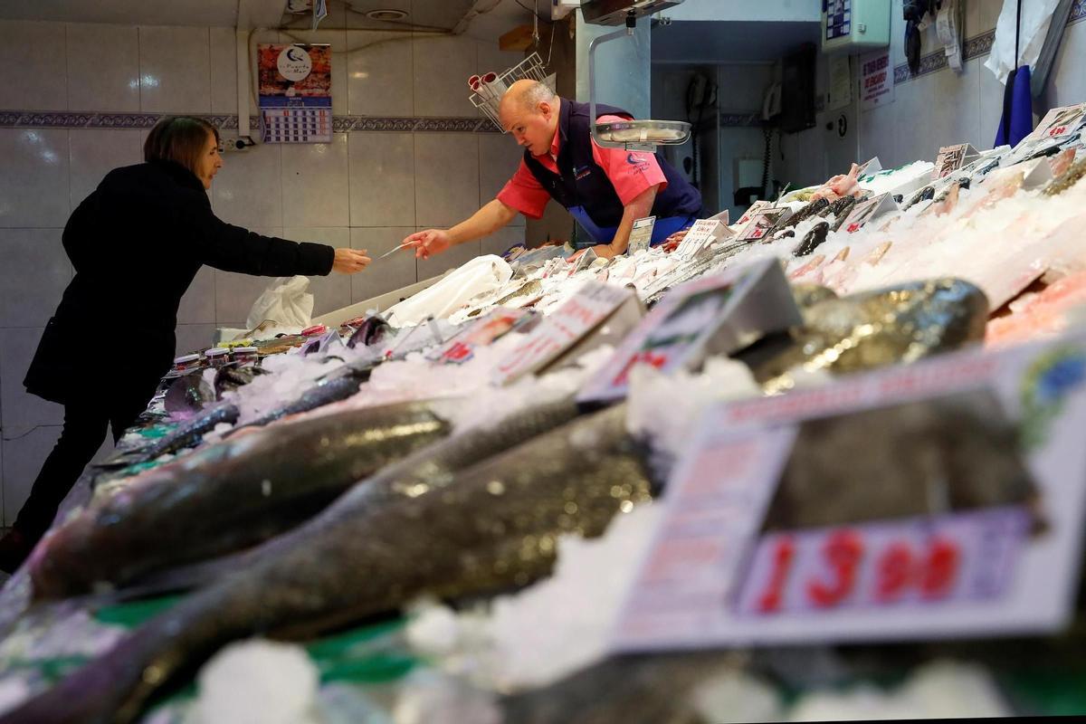 Un pescatero atiende a un cliente.