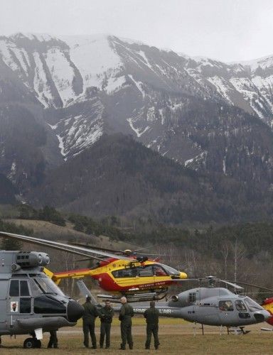 Rescue helicopters from the French Securite Civile and the Air Force are seen in front of the French Alps during a rescue operation next to the crash site of an Airbus A320