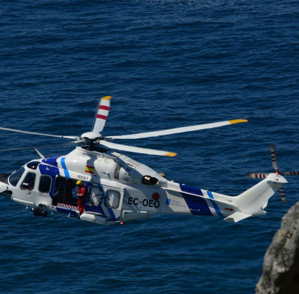 El helicóptero ‘Pesca 1’, ayer, recorriendo la costa. |   // G. NÚÑEZ