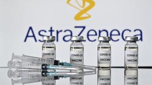 (FILES) In this file photo taken on November 17  2020 An illustration picture shows vials with Covid-19 Vaccine stickers attached and syringes with the logo of British pharmaceutical company AstraZeneca  - Pharmaceutical giant AstraZeneca s Russian branch said on December 11  2020 it would use part of Russia s homemade Sputnik V vaccine in further clinical trials  (Photo by JUSTIN TALLIS   AFP)