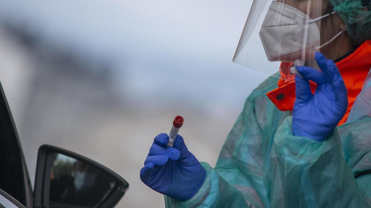 Un sanitario recoge una muestra de saliva en un cribado en Galicia.