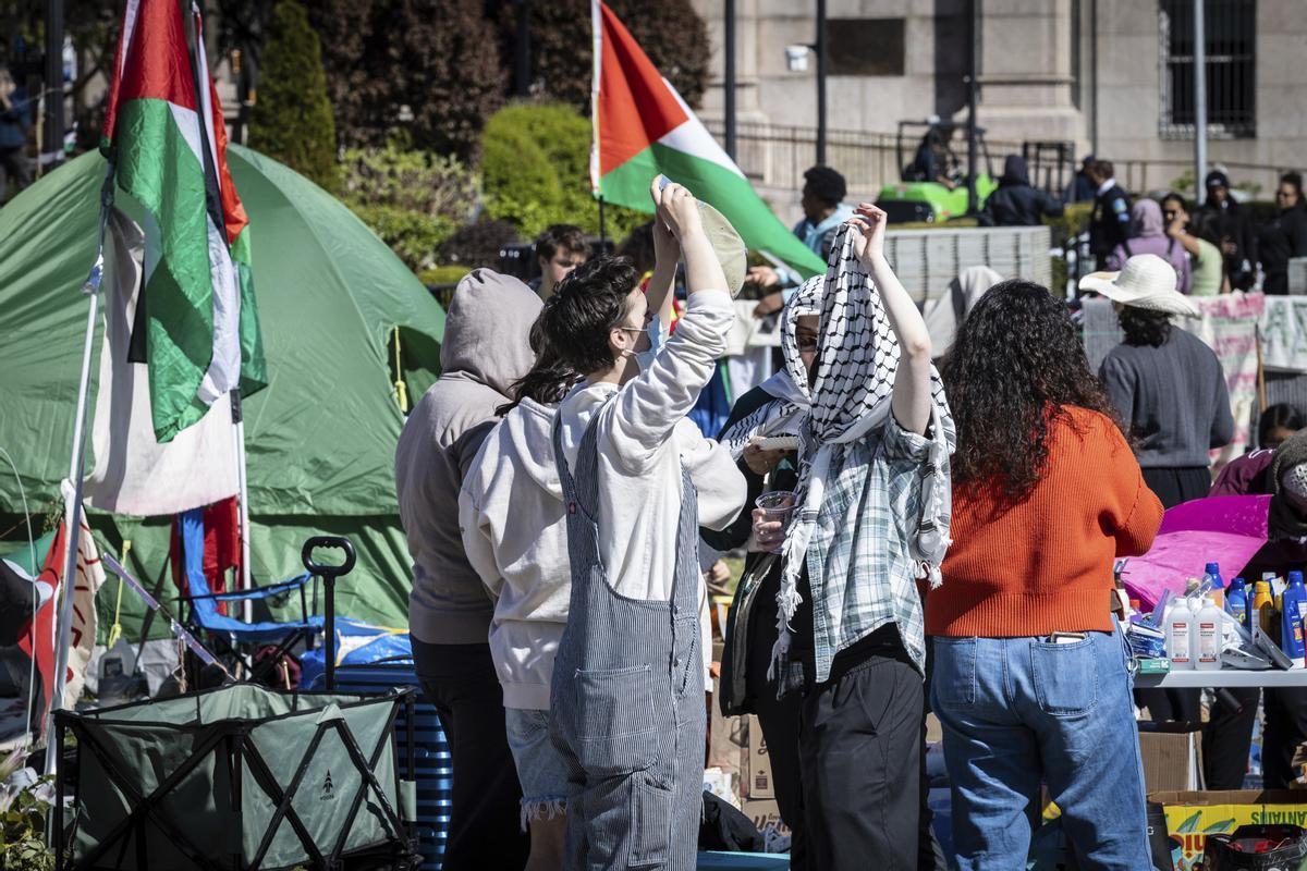 Two student protesters converse at the Pro-Palestine protest encampment at the Columbia University campus in New York on Monday April 22, 2024. (AP Photo/Stefan Jeremiah)