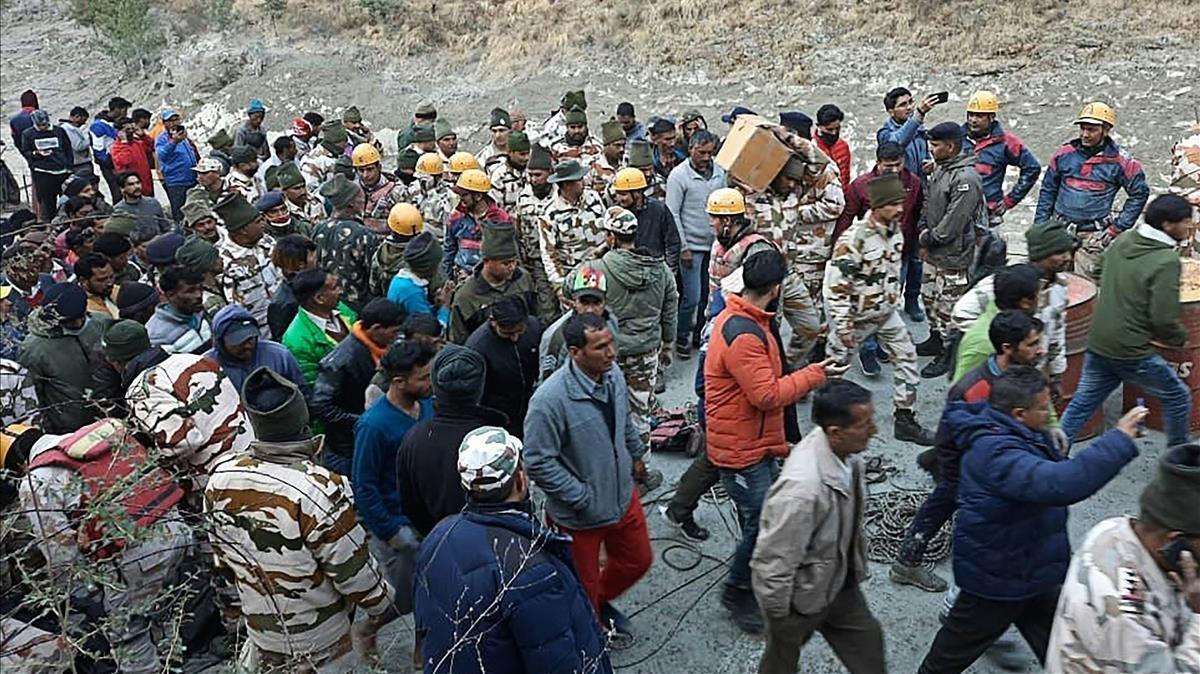 This handout photo taken on February 7  2021 and released by the Indo-Tibetan Border Police (ITBP) shows onlookers and members of the Indo-Tibetan Border Police (ITBP) during a rescue operation after a broken glacier caused a major river surge that swept away bridges and roads  at Reni village in Chamoli district of Uttarakhand  - Three people were confirmed dead and at least 150 were missing in northern India after a broken glacier caused a major river surge that swept away bridges and roads on February 7  police said  (Photo by -   Indo-Tibetan Border Police (ITBP)   AFP)   RESTRICTED TO EDITORIAL USE - MANDATORY CREDIT  AFP PHOTO  Indo-Tibetan Border Police (ITBP)   - NO MARKETING - NO ADVERTISING CAMPAIGNS - DISTRIBUTED AS A SERVICE TO CLIENTS  - NO ARCHIVE