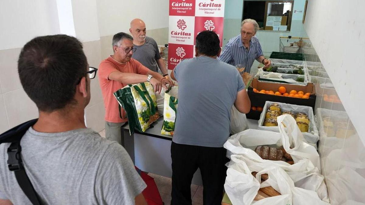 Imagen de archivo de voluntarios de Cáritas Interparroquial de Vila-real repartiendo comida preparada a personas en riesgo de exclusión social.