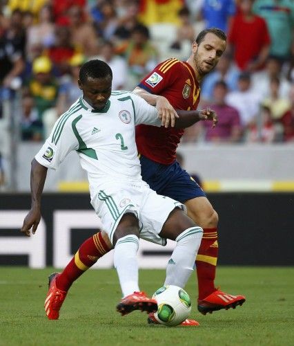 Nigeria's Oboabona and Spain's Soldado fight for the ball during their Confederations Cup Group B soccer match at the Estadio Castelao in Fortaleza