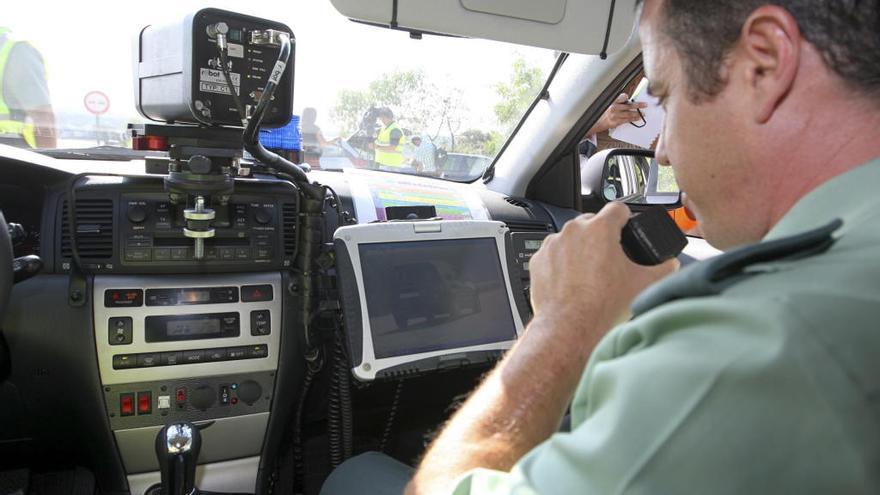 Un agente de Tráfico vigila la circulación con un radar // Manuel H. de León