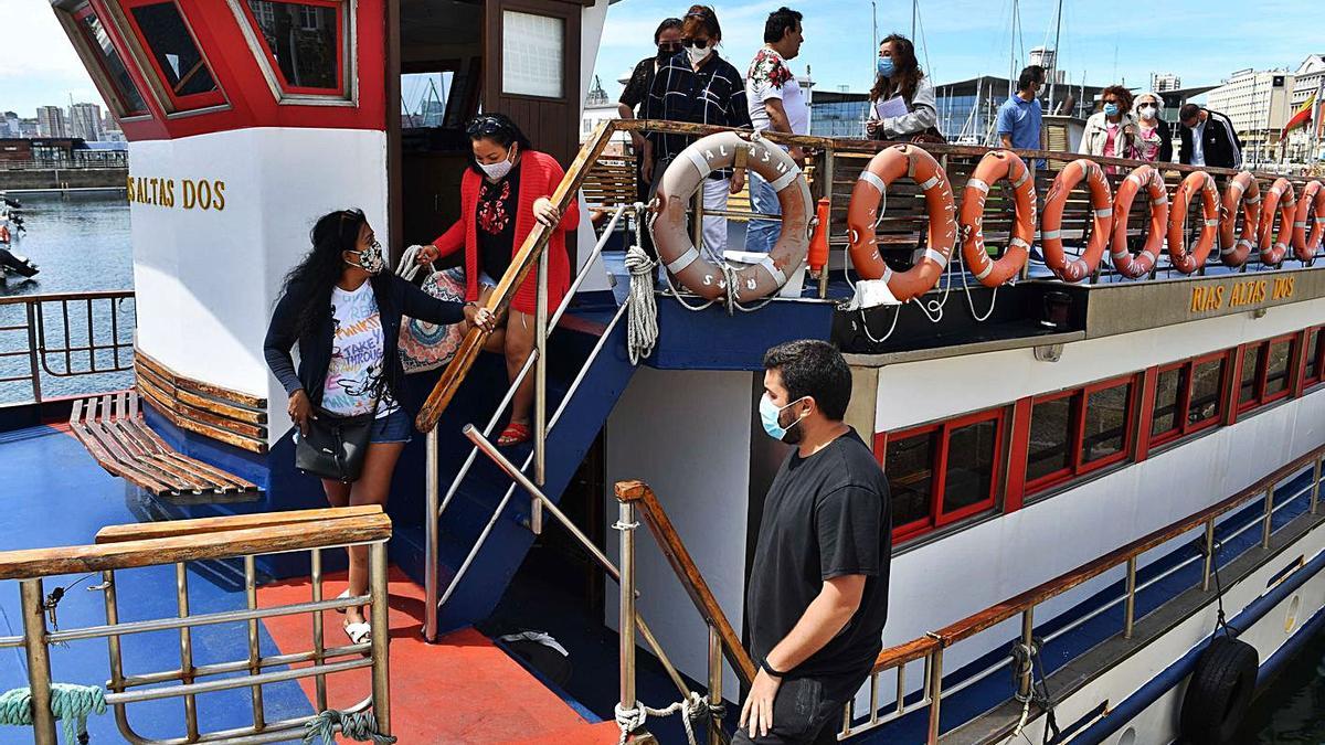 Turistas bajan de la embarcación ‘Rías Altas Dos’, en la Marina.  | // VÍCTOR ECHAVE