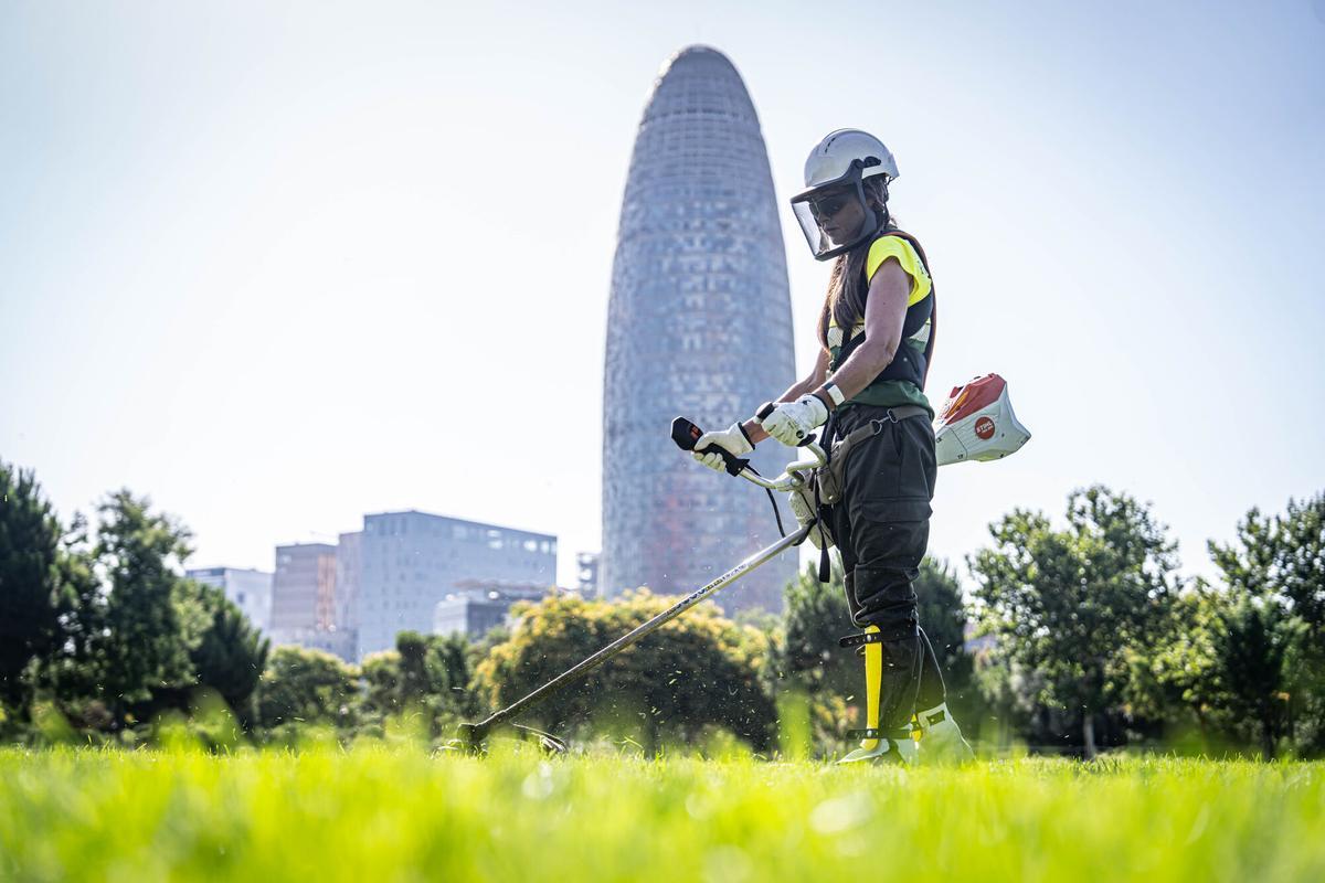Trabajadores de Parques y Jardines utilizan pulseras inteligentes que alertan cuando la temperatura corporal alcanza niveles de riesgo de sufrir un golpe de calor, dentro de la campaña impulsada por el Ayuntamiento de Barcelona para proteger a los empleados expuestos a altas temperaturas durante la jornada laboral. En la Clariana de Glòries, Barcelona, a 23 de junio de 2026. AUTOR: MANU MITRU | EPC