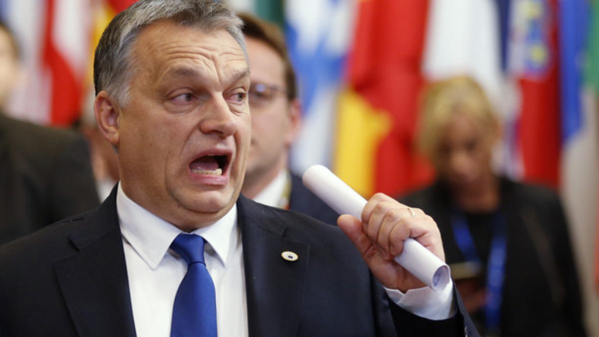 Hungary's PM Orban reacts as he leaves a EU leaders summit in Brussels