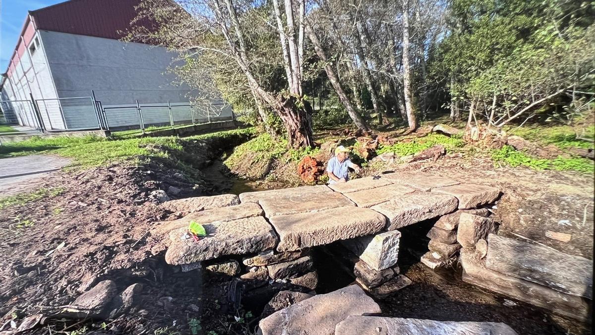 Últimos retoques de la reconstrucción del puente de piedra sobre el río Saíñas a la altura de A Rúa.