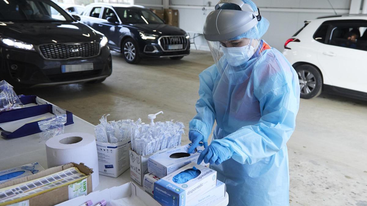 Una sanitaria se cambia los guantes tras realizar una prueba PCR en un hospital de Madrid.