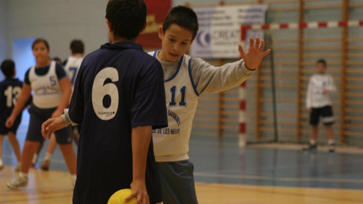 Un grupo de niños disputa un partido de balonmano.