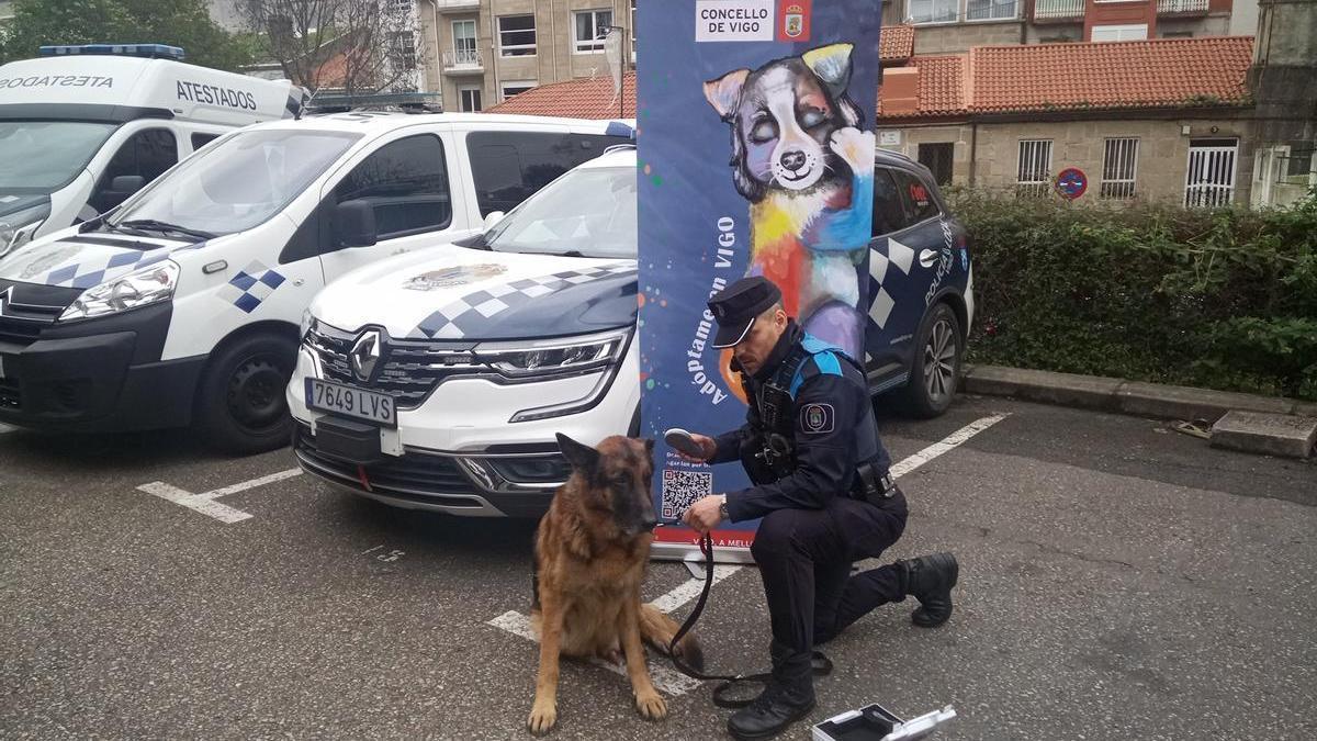 Un agente y un perro, con uno de los lectores de microchips.