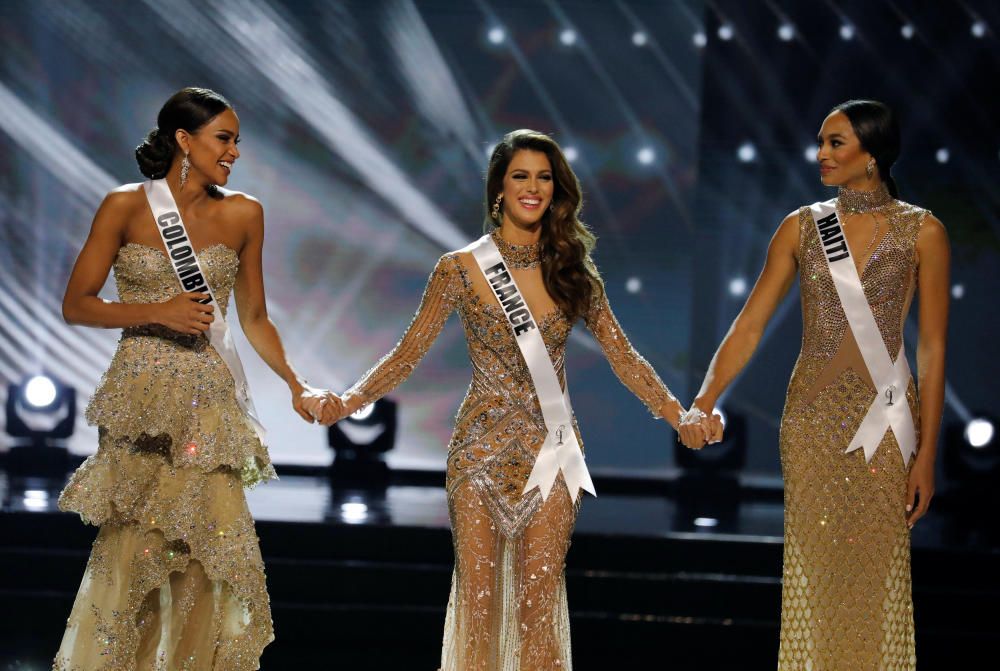 Miss France Iris Mittenaere holds hands with ...