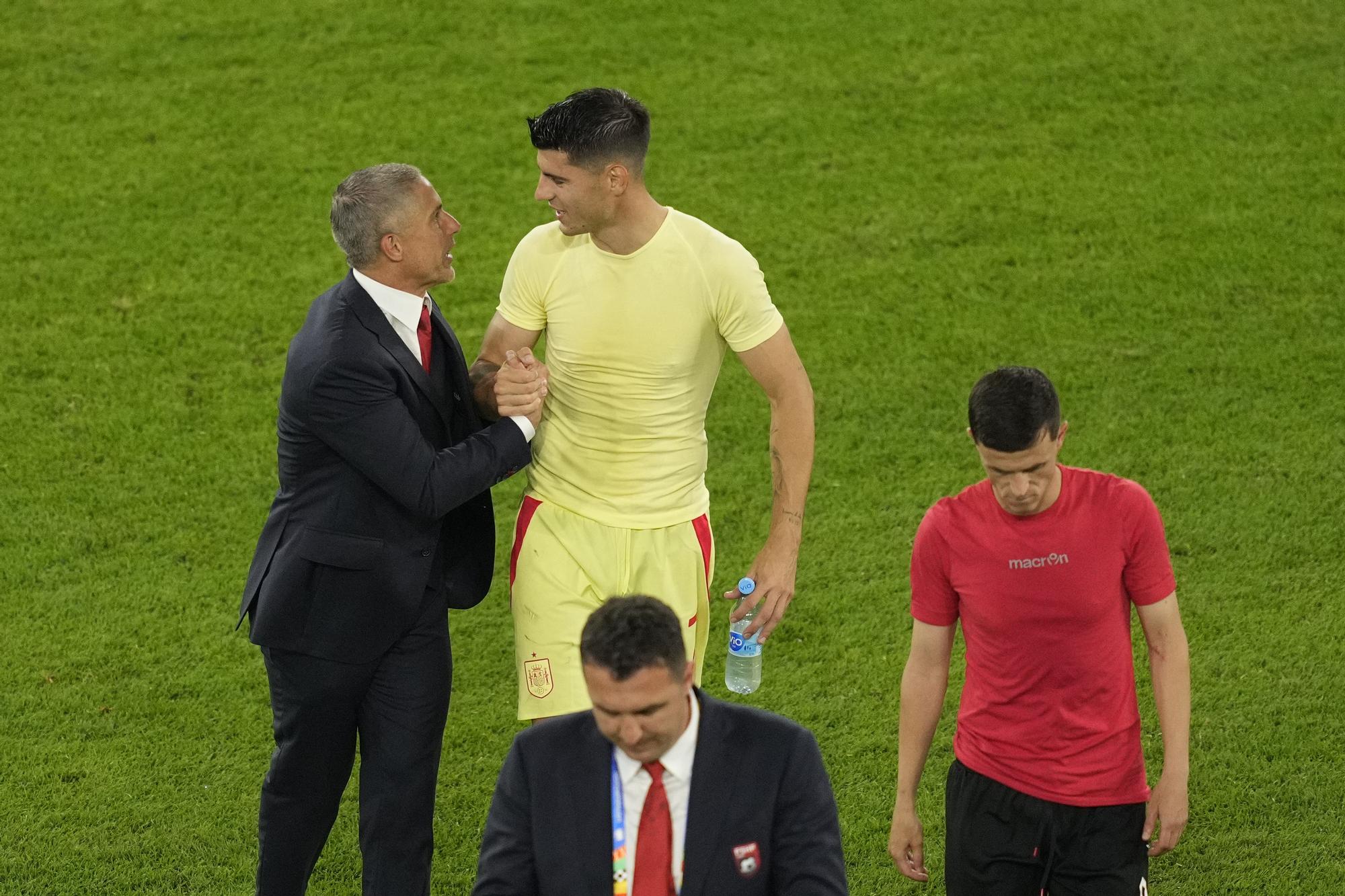 Albania's head coach Sylvinho shakes hands with Spain's Alvaro Morata at the end of a Group B match between Albania and Spain at the Euro 2024 soccer tournament in Duesseldorf, Germany, Monday, June 24, 2024. (AP Photo/Andreea Alexandru)