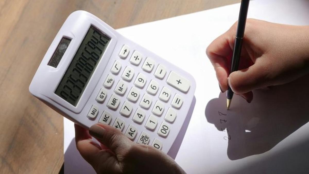 Archivo - Imagen de archivo de una persona con una calculadora