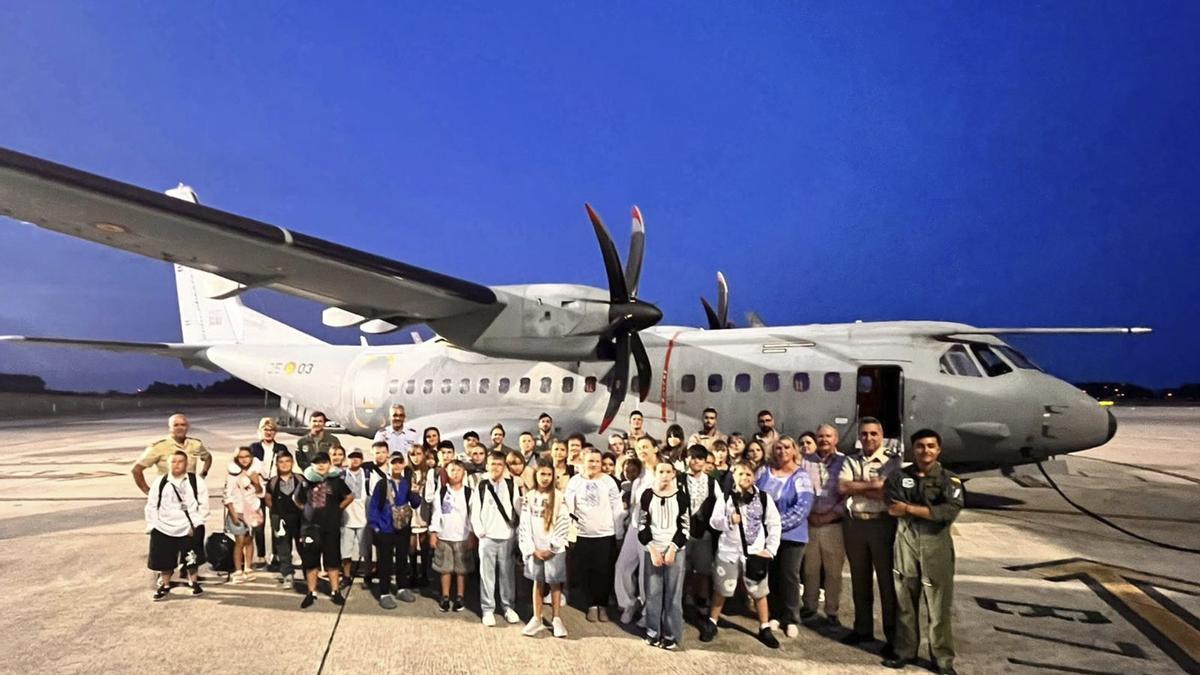 Los menores ucranianos y sus acompañantes, recién llegados al Aeropuerto de Asturias con Jesús Moreno del Valle, segundo por la derecha