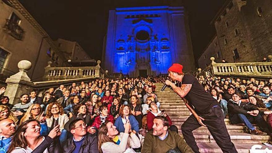 Macaco, a les escales de la Catedral i cantant entre el públic, dissabte.