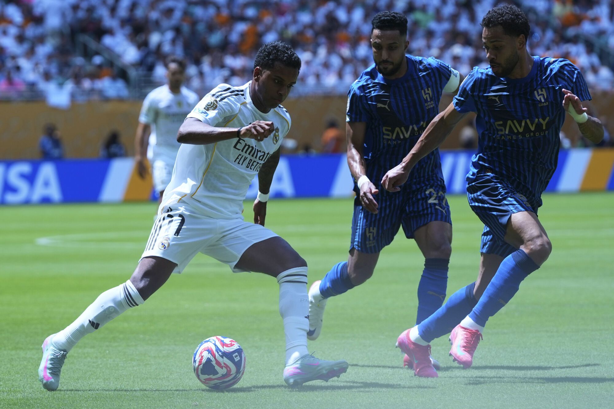 Real Madrid's Rodrygo, left, controls the ball as Al-Hilal's Renan Lodi, right, and Salem Al-Dawsari defend during the Club World Cup group H soccer match between Real Madrid and Al Hilal in Miami, Fla., Wednesday, June 18, 2025. (AP Photo/Lynne Sladky). EDITORIAL USE ONLY/ONLY ITALY AND SPAIN