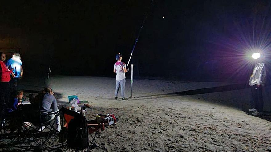 Una familia saliendo por la noche a pescar en Santa Pola, días antes del toque de queda.