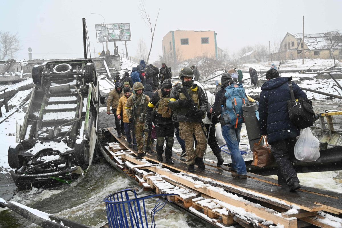 Soldados ucranianos cruzan un puente destruido durante la evacuación de civiles de la ciudad de Irpin, al noroeste de Kiev