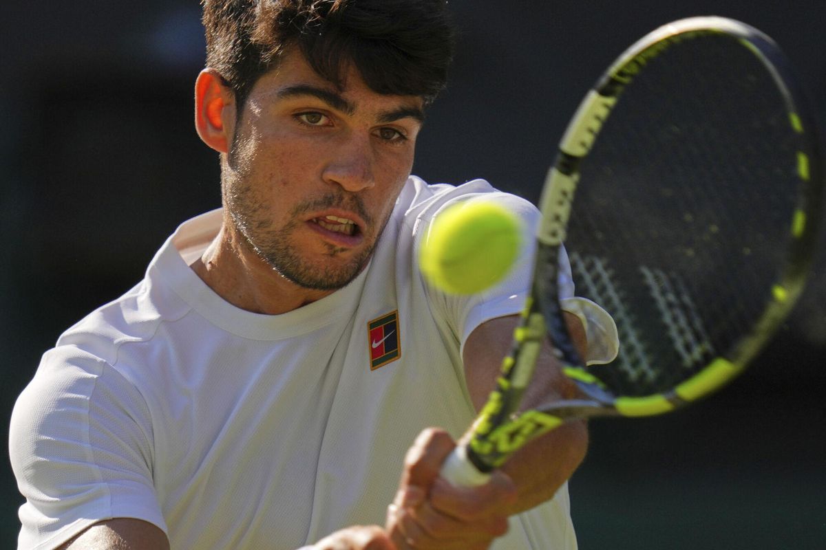 Spains Carlos Alcaraz returns to Britains Cameron Norrie during a quarterfinal mens singles match at the Wimbledon Tennis Championships in London, Tuesday, July 8, 2025. (AP Photo/Kirsty Wigglesworth)