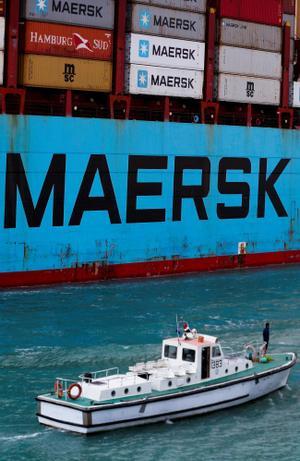 Shipping containers are transported on a Maersk Line vessel through the Suez Canal in Suez