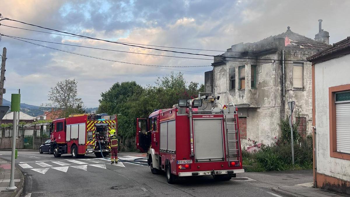 Dotaciones de bomberos ante la casa okupa de la calle Ceboleira que ardió.