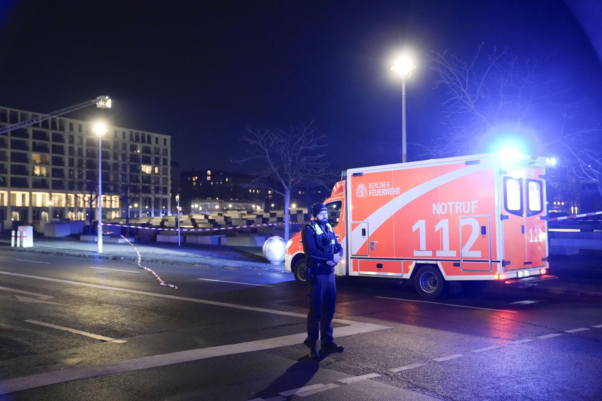 A police officer guards at the cordoned off Holocaust memorial after a man was attacked at the memorial site in Berlin, Germany, Friday, Feb. 21, 2025. (AP Photo/Ebrahim Noroozi)