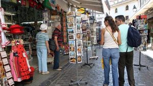 Turistas pasean por una calle en España.