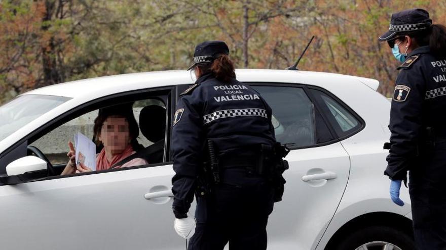 Dos agentes de Policía preguntan a una conductora por el motivo para desplazarse.