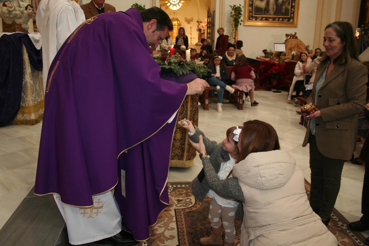 El párroco del Carmen, Juan José Torreglosa, bendecía el Niño Jesús de una pequeña.