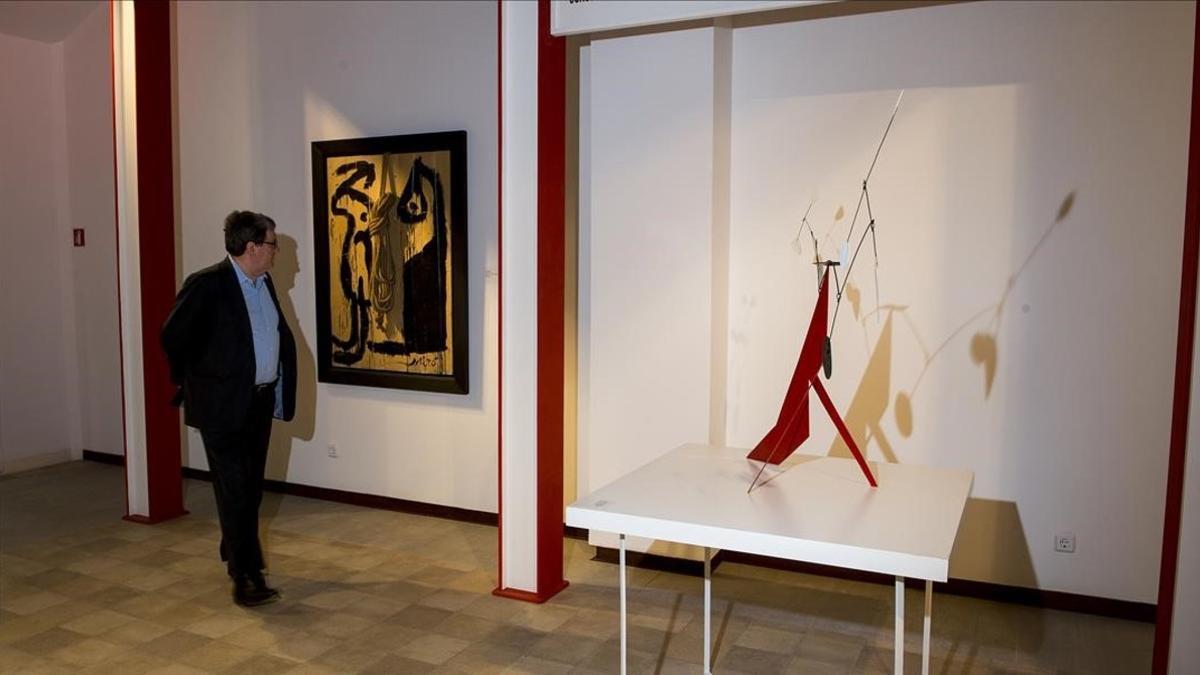 Juan Manuel Bonet, comisario de la exposición 'Artistas revolucionarios', en la galería Mayoral, ante 'Painting', de Miró, y 'The red base', de Alexander Calder.