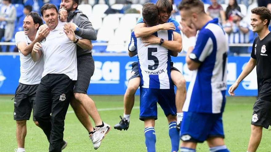 Cristóbal Parralo (a la izquierda), abrazado por sus ayudantes al finalizar el partido.