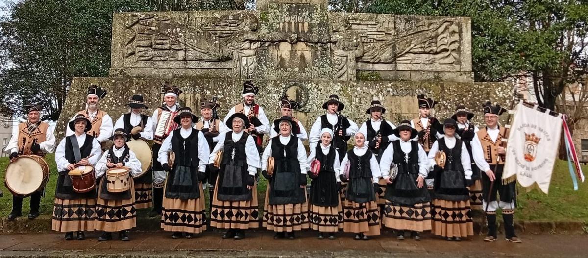 Formación reciente de Os Dezas de Moneixas delante de la estatua de Loriga, en Lalín.